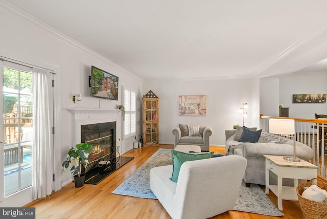 6498 Milva Ln, Springfield, VA 22150 - living room featuring ornamental molding, healthy amount of natural light, wood finished floors, and a glass covered fireplace