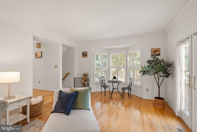 6498 Milva Ln, Springfield, VA 22150 - living area with healthy amount of natural light, ornamental molding, and light wood-style flooring