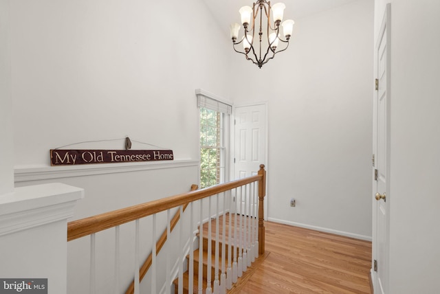 6498 Milva Ln, Springfield, VA 22150 - hall with an upstairs landing, a chandelier, light wood-style floors, and a high ceiling