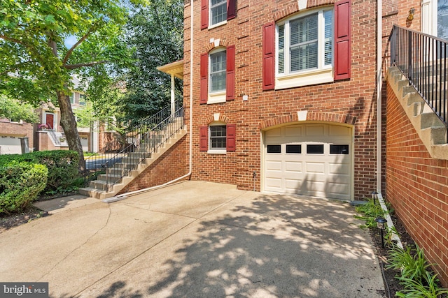 6498 Milva Ln, Springfield, VA 22150 - view of side of home with a garage, concrete driveway, brick siding, and stairs