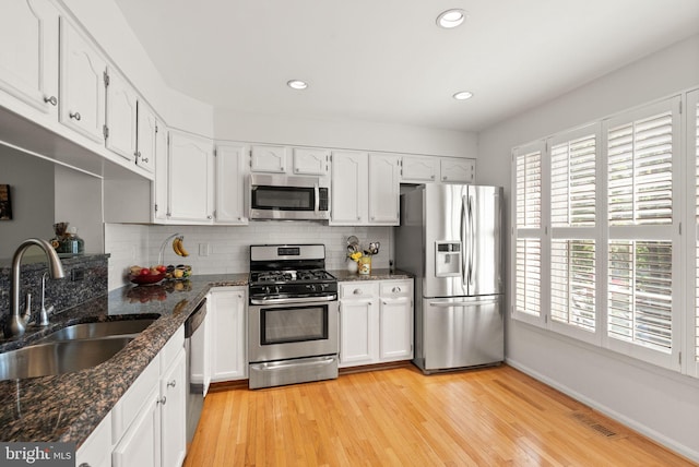 6498 Milva Ln, Springfield, VA 22150 - kitchen featuring stainless steel appliances, white cabinetry, tasteful backsplash, recessed lighting, and light wood-style flooring