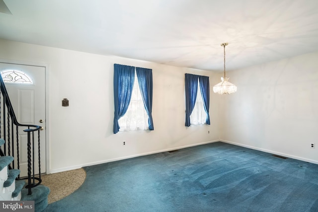 330 N Liberty St, Coopersburg, PA 18036 - empty room with stairway, carpet, and a chandelier