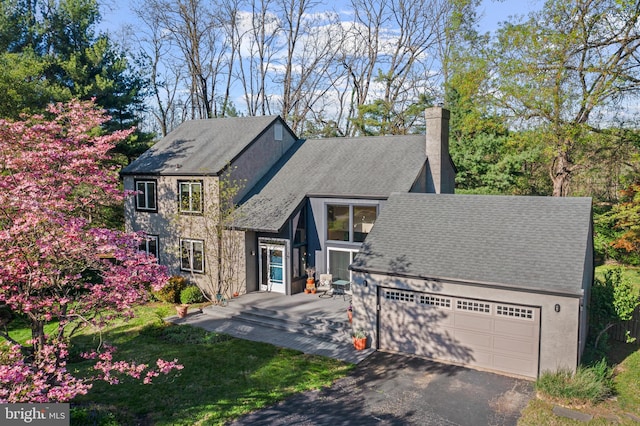 39 Haymarket Ln, Bryn Mawr, PA 19010 - view of front of property with a chimney, an attached garage, asphalt driveway, and a shingled roof