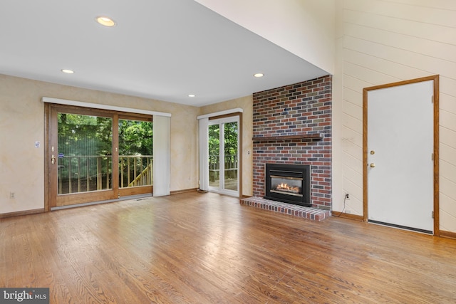 39 Haymarket Ln, Bryn Mawr, PA 19010 - unfurnished living room with wood finished floors, a brick fireplace, and recessed lighting
