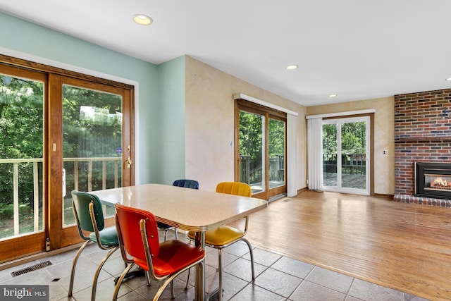 39 Haymarket Ln, Bryn Mawr, PA 19010 - tiled dining space featuring a fireplace and recessed lighting