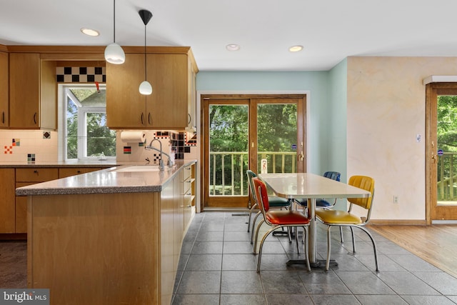 39 Haymarket Ln, Bryn Mawr, PA 19010 - kitchen with plenty of natural light, tasteful backsplash, recessed lighting, decorative light fixtures, and a peninsula