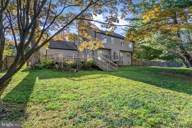 39 Haymarket Ln, Bryn Mawr, PA 19010 - fenced backyard with a wooden deck and stairway