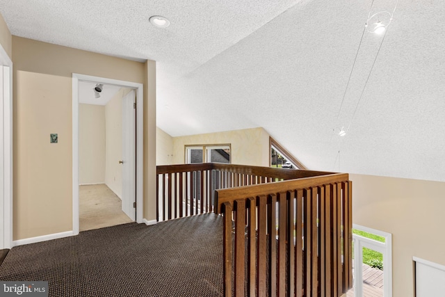 39 Haymarket Ln, Bryn Mawr, PA 19010 - corridor featuring a textured ceiling, an upstairs landing, carpet, and vaulted ceiling