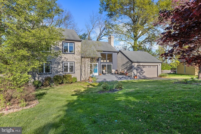 39 Haymarket Ln, Bryn Mawr, PA 19010 - back of property featuring a chimney, a garage, and a yard