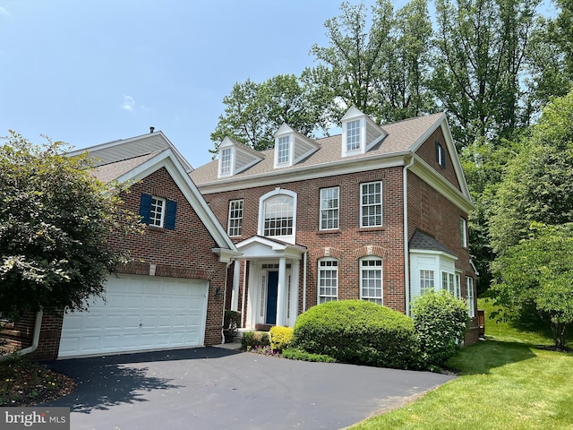 206 Excalibur Dr, Newtown Square, PA 19073 - colonial home featuring driveway, brick siding, an attached garage, and a front yard