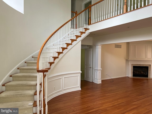 206 Excalibur Dr, Newtown Square, PA 19073 - stairway featuring wood finished floors, a towering ceiling, and a fireplace with flush hearth