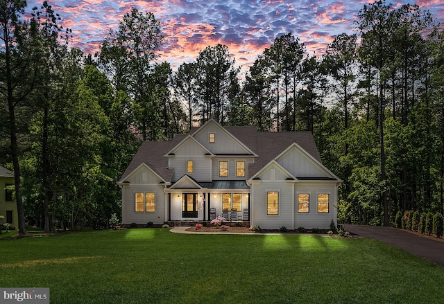 103 Wateredge Ln, Fredericksburg, VA 22406 - view of front of house featuring covered porch, board and batten siding, a front yard, a standing seam roof, and a metal roof