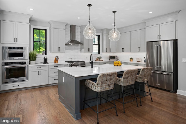 103 Wateredge Ln, Fredericksburg, VA 22406 - kitchen with high quality appliances, wall chimney exhaust hood, light countertops, backsplash, and recessed lighting