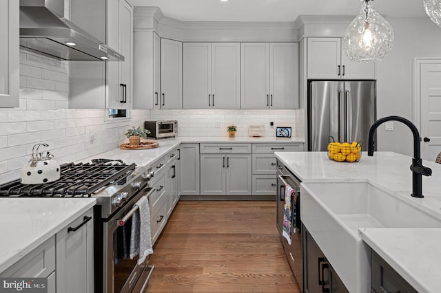 103 Wateredge Ln, Fredericksburg, VA 22406 - kitchen with appliances with stainless steel finishes, wall chimney range hood, backsplash, dark wood-style flooring, and pendant lighting