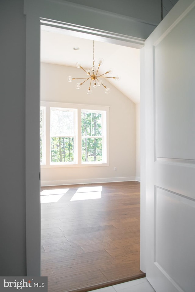 103 Wateredge Ln, Fredericksburg, VA 22406 - spare room featuring a chandelier, wood finished floors, and vaulted ceiling