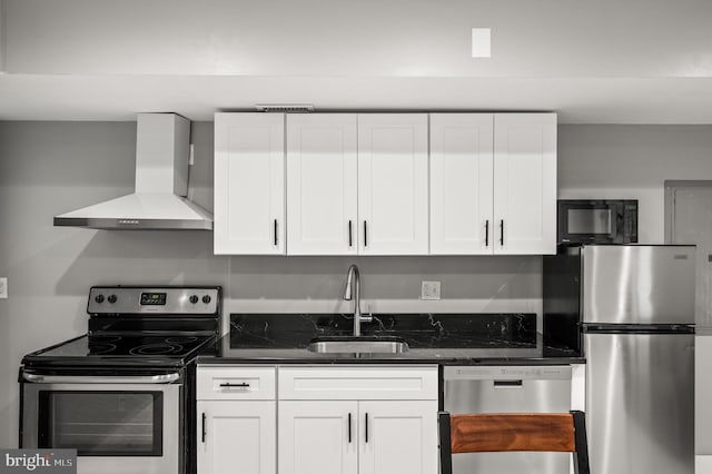 1719 W Norris St, Philadelphia, PA 19121 - kitchen with wall chimney range hood, appliances with stainless steel finishes, white cabinets, and dark stone counters