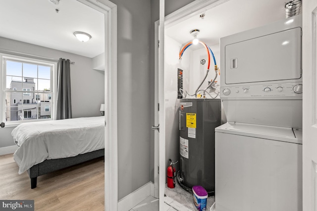 1719 W Norris St, Philadelphia, PA 19121 - laundry area featuring electric water heater, estacked washer and dryer, and light wood-style floors