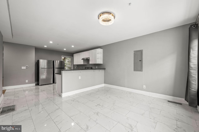 1719 W Norris St, Philadelphia, PA 19121 - kitchen with freestanding refrigerator, electric panel, dark countertops, white cabinetry, and light marble finish floors