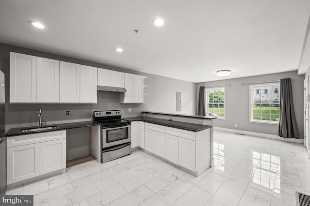 1719 W Norris St, Philadelphia, PA 19121 - kitchen featuring stainless steel electric range oven, under cabinet range hood, light marble finish flooring, a peninsula, and recessed lighting