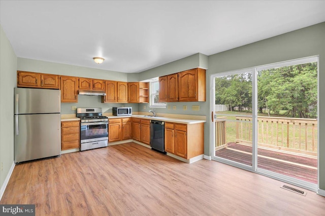 725 Logan Ave, Deptford, NJ 08096 - kitchen featuring stainless steel appliances, under cabinet range hood, light countertops, and light wood-style floors