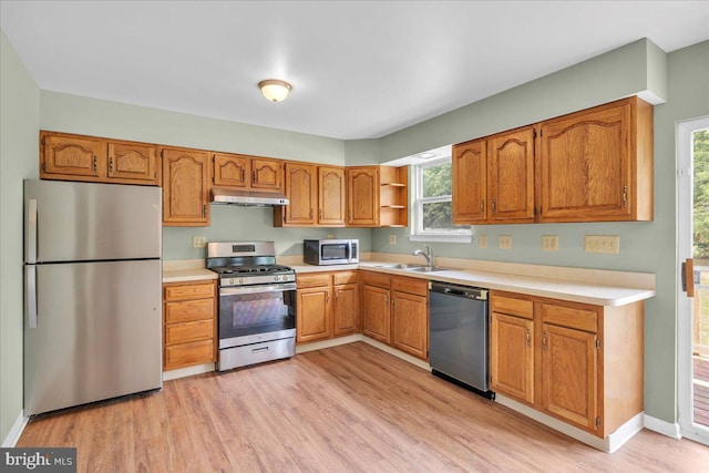 725 Logan Ave, Deptford, NJ 08096 - kitchen with stainless steel appliances, under cabinet range hood, light countertops, light wood-style flooring, and brown cabinets
