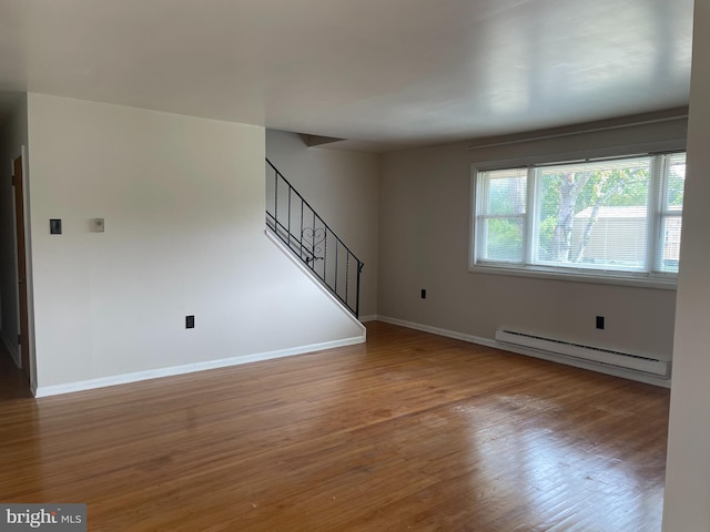 122 Elmtowne Blvd, Hammonton, NJ 08037 - unfurnished living room with baseboard heating, wood finished floors, and stairway