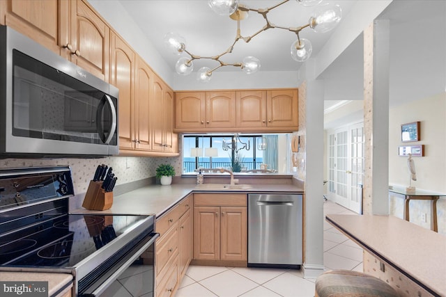 906 S Edgewater House Rd Unit 906S, Bethany Beach, DE 19930 - kitchen with stainless steel appliances, light tile patterned floors, light brown cabinets, and light countertops