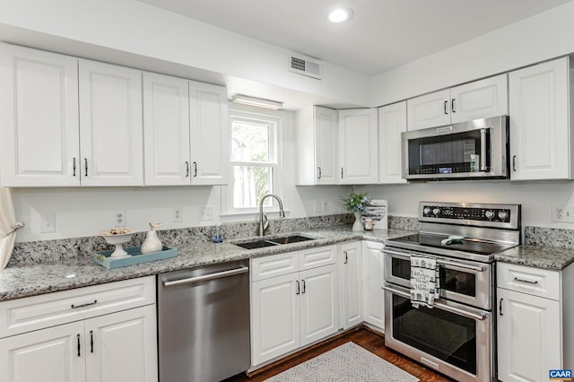 1632 Farm Brook Pl, Charlottesville, VA 22901 - kitchen with stainless steel appliances, dark wood-style flooring, white cabinets, recessed lighting, and light stone counters