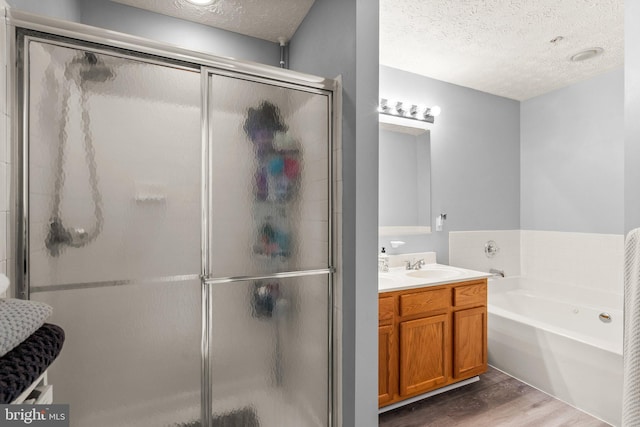 50 Amberstone Ct, Annapolis, MD 21403 - full bathroom featuring a textured ceiling, wood finished floors, a stall shower, a garden tub, and vanity