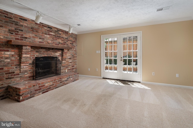 6708 Langston Blvd Unit A, Arlington, VA 22205 - unfurnished living room featuring rail lighting, a textured ceiling, french doors, carpet flooring, and a brick fireplace