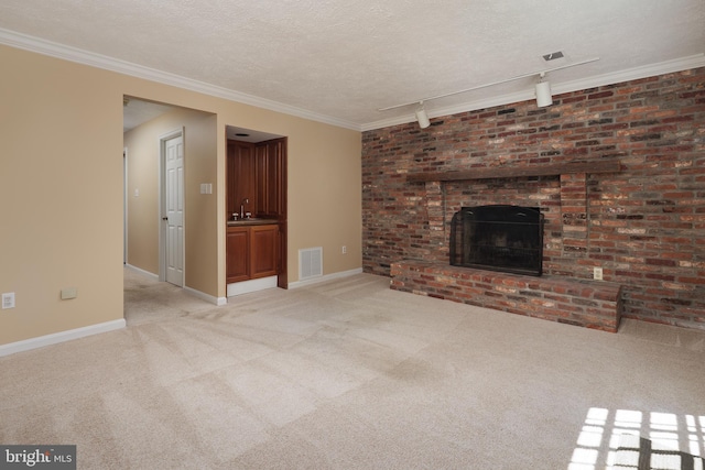 6708 Langston Blvd Unit A, Arlington, VA 22205 - unfurnished living room featuring light carpet, a brick fireplace, a textured ceiling, and track lighting