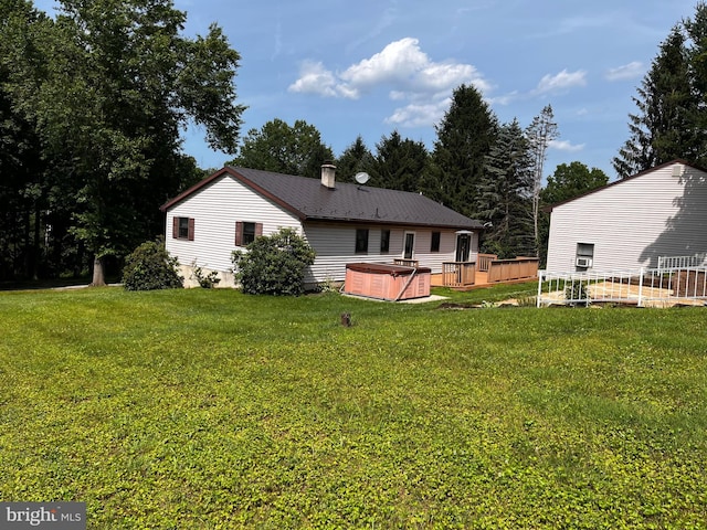 636 Pigeon Creek Rd, Pottstown, PA 19465 - back of house with a hot tub, a yard, and a chimney