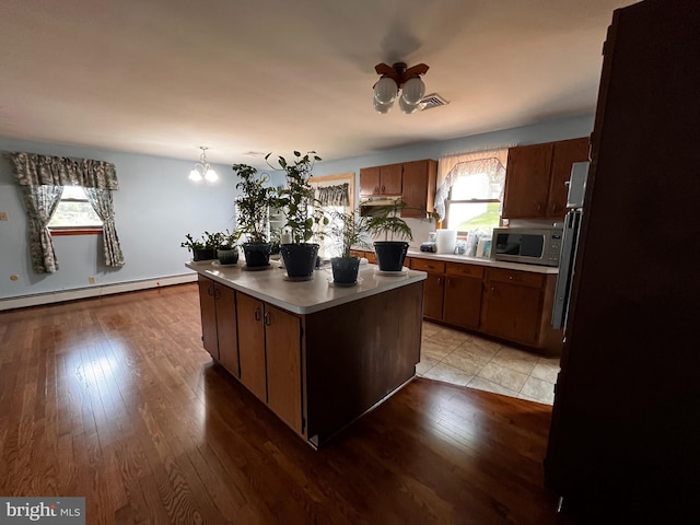636 Pigeon Creek Rd, Pottstown, PA 19465 - kitchen featuring stainless steel microwave, a baseboard radiator, light wood-type flooring, light countertops, and a kitchen island