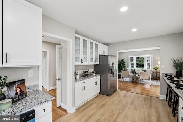 202 Piping Rock Dr, Silver Spring, MD 20905 - kitchen with stainless steel fridge, glass insert cabinets, light wood-style flooring, white cabinets, and recessed lighting
