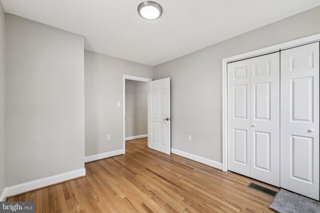 202 Piping Rock Dr, Silver Spring, MD 20905 - unfurnished bedroom featuring light wood-style flooring and a closet