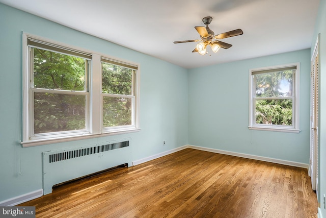 4004 Beecher St NW Unit 304, Washington, DC 20007 - spare room featuring radiator heating unit, wood finished floors, and ceiling fan