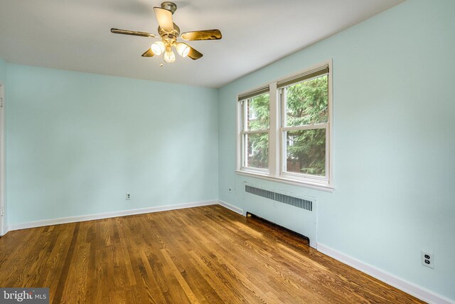 4004 Beecher St NW Unit 304, Washington, DC 20007 - spare room featuring radiator heating unit, wood finished floors, and a ceiling fan