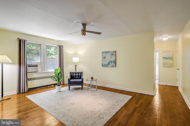 4004 Beecher St NW Unit 304, Washington, DC 20007 - sitting room with radiator heating unit, a ceiling fan, and dark wood-style flooring