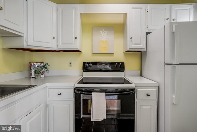 4004 Beecher St NW Unit 304, Washington, DC 20007 - kitchen featuring freestanding refrigerator, electric range, white cabinetry, and light countertops