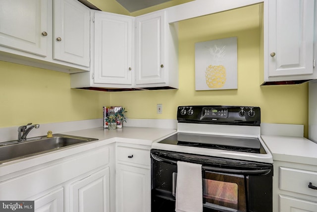 4004 Beecher St NW Unit 304, Washington, DC 20007 - kitchen with black / electric stove, white cabinetry, and light countertops