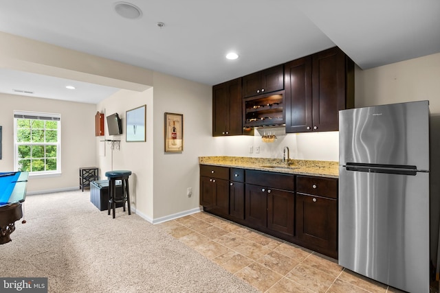 22351 Winding Woods Way, Clarksburg, MD 20871 - kitchen with freestanding refrigerator, dark brown cabinetry, light stone countertops, and recessed lighting