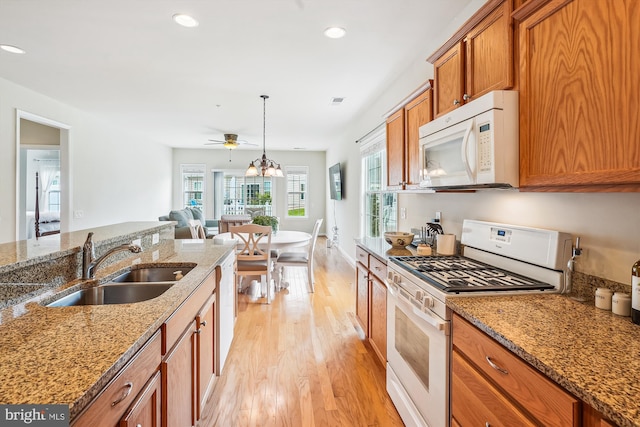 130 Ambrose Ln, Fredericksburg, VA 22406 - kitchen featuring white appliances, brown cabinetry, light wood-type flooring, light stone countertops, and recessed lighting