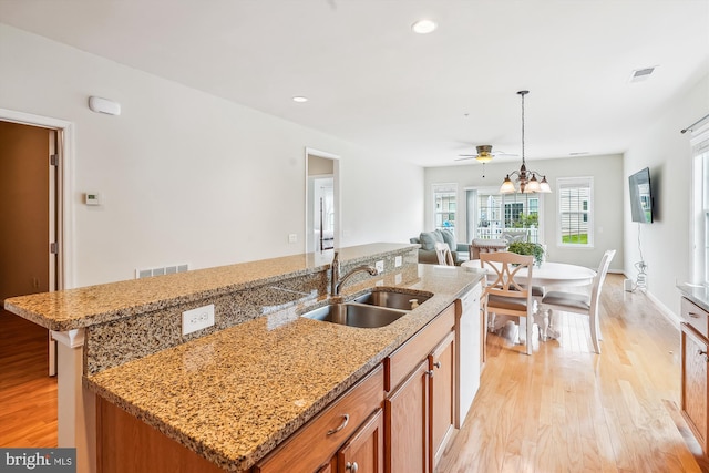 130 Ambrose Ln, Fredericksburg, VA 22406 - kitchen with light wood finished floors, brown cabinetry, an island with sink, open floor plan, and white dishwasher