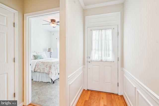 130 Ambrose Ln, Fredericksburg, VA 22406 - doorway to outside with a wainscoted wall, a decorative wall, light wood-style floors, ceiling fan, and ornamental molding
