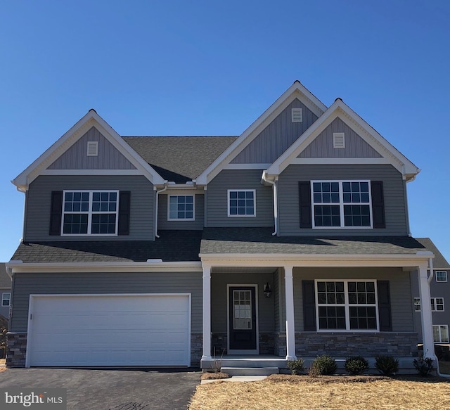 106 Saratoga Ct, North East, MD 21901 - craftsman-style house with a porch, an attached garage, stone siding, and asphalt driveway