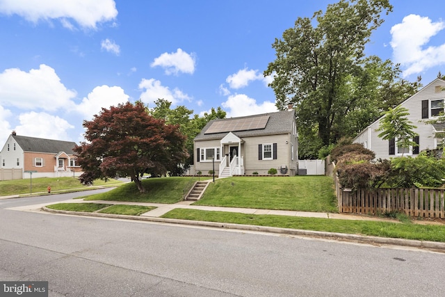 2619 Poplar Dr, Baltimore, MD 21207 - view of front facade with roof mounted solar panels and a chimney