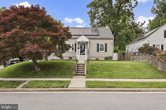 2619 Poplar Dr, Baltimore, MD 21207 - view of front of property featuring roof mounted solar panels, a chimney, and roof with shingles