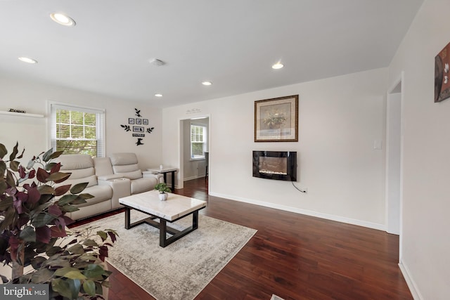2619 Poplar Dr, Baltimore, MD 21207 - living room featuring a glass covered fireplace, dark wood-type flooring, and recessed lighting