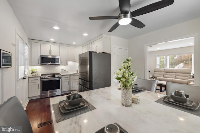 2619 Poplar Dr, Baltimore, MD 21207 - kitchen with stainless steel appliances, a ceiling fan, decorative backsplash, dark wood-type flooring, and recessed lighting