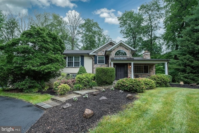 496 Black Swan Ln, Berwyn, PA 19312 - split level home with stone siding, a chimney, stucco siding, and a front yard